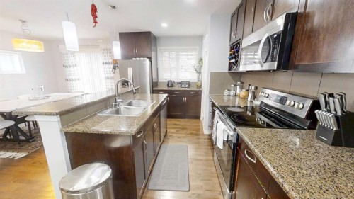 103 Prestwick Villas Se, Calgary, AB - Indoor Photo Showing Kitchen With Stainless Steel Kitchen With Double Sink With Upgraded Kitchen