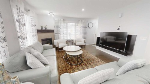 103 Prestwick Villas Se, Calgary, AB - Indoor Photo Showing Living Room With Fireplace