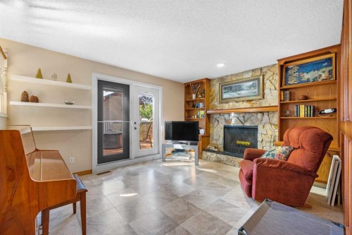 7 Bernard Court Nw, Calgary, AB - Indoor Photo Showing Living Room With Fireplace