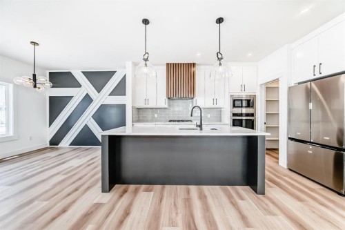 708 Mandalay Avenue, Carstairs, AB - Indoor Photo Showing Kitchen With Upgraded Kitchen