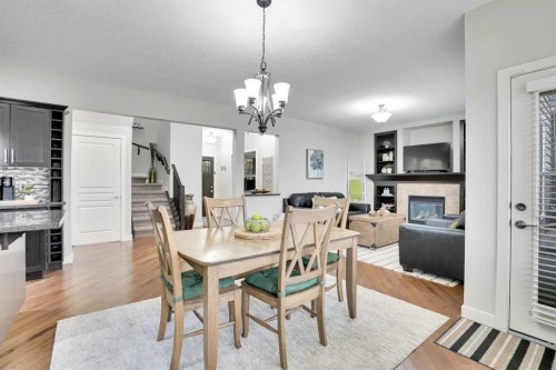 142 Luxstone View Sw, Airdrie, AB - Indoor Photo Showing Dining Room With Fireplace
