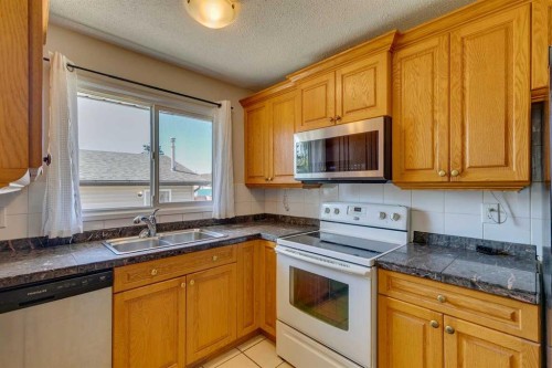 2823 Dover Ridge Drive Se, Calgary, AB - Indoor Photo Showing Kitchen With Double Sink