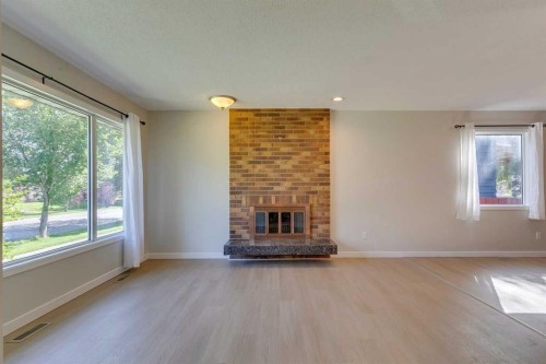 2823 Dover Ridge Drive Se, Calgary, AB - Indoor Photo Showing Living Room With Fireplace