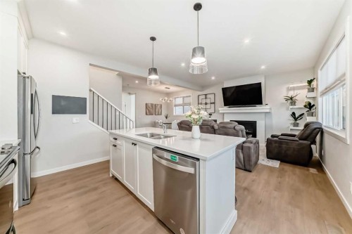 26 Lavender Drive Se, Calgary, AB - Indoor Photo Showing Kitchen With Fireplace With Stainless Steel Kitchen With Double Sink With Upgraded Kitchen
