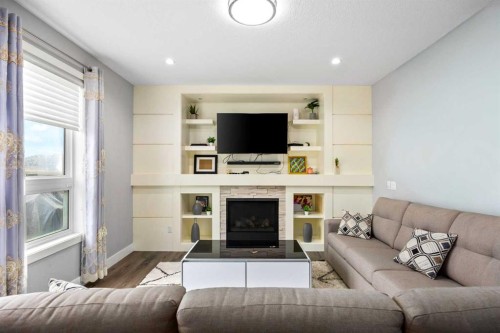 106 Baysprings Gardens Sw, Airdrie, AB - Indoor Photo Showing Living Room With Fireplace