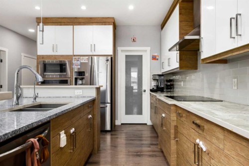 106 Baysprings Gardens Sw, Airdrie, AB - Indoor Photo Showing Kitchen With Double Sink With Upgraded Kitchen