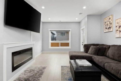 106 Baysprings Gardens Sw, Airdrie, AB - Indoor Photo Showing Living Room With Fireplace