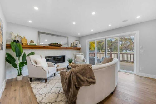 711 Mckenzie Lake Bay Se, Calgary, AB - Indoor Photo Showing Living Room With Fireplace