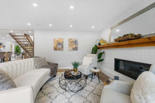 711 Mckenzie Lake Bay Se, Calgary, AB - Indoor Photo Showing Living Room With Fireplace