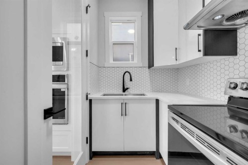 203 Kinniburgh Place, Chestermere, AB - Indoor Photo Showing Kitchen With Double Sink With Upgraded Kitchen