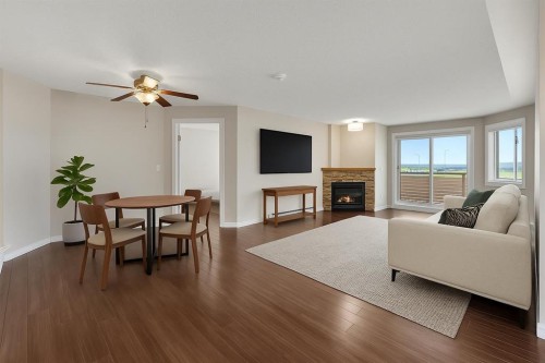 2107-7451 Springbank Boulevard Sw, Calgary, AB - Indoor Photo Showing Living Room With Fireplace