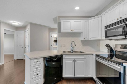 2107-7451 Springbank Boulevard Sw, Calgary, AB - Indoor Photo Showing Kitchen With Double Sink