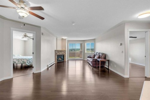 2107-7451 Springbank Boulevard Sw, Calgary, AB - Indoor Photo Showing Living Room With Fireplace