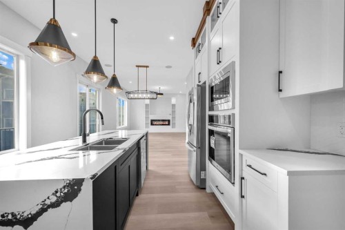 327 Kinniburgh Place, Chestermere, AB - Indoor Photo Showing Kitchen With Double Sink With Upgraded Kitchen