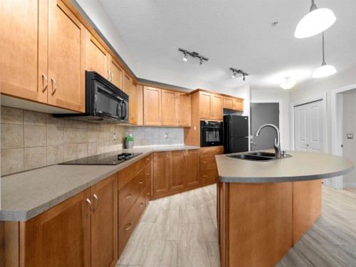 311-3101 34 Avenue Nw, Calgary, AB - Indoor Photo Showing Kitchen With Double Sink