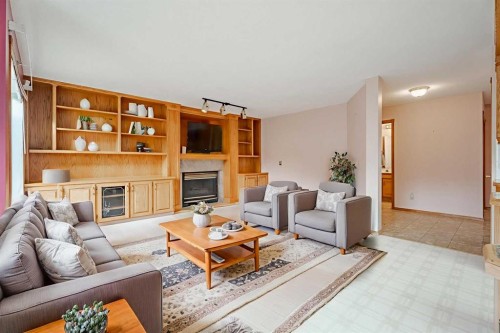 301 Riverview Green, Cochrane, AB - Indoor Photo Showing Living Room With Fireplace