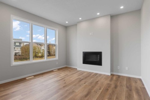 106 Monterey Bay Se, High River, AB - Indoor Photo Showing Living Room With Fireplace