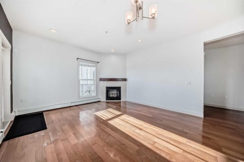103-4704 Stanley Road Sw, Calgary, AB - Indoor Photo Showing Living Room With Fireplace