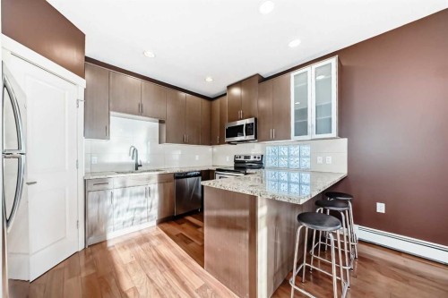 103-4704 Stanley Road Sw, Calgary, AB - Indoor Photo Showing Kitchen With Stainless Steel Kitchen With Upgraded Kitchen