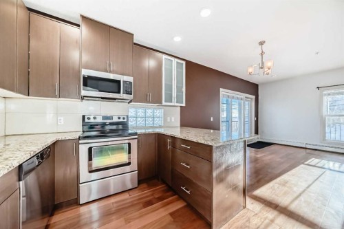 103-4704 Stanley Road Sw, Calgary, AB - Indoor Photo Showing Kitchen With Stainless Steel Kitchen With Upgraded Kitchen