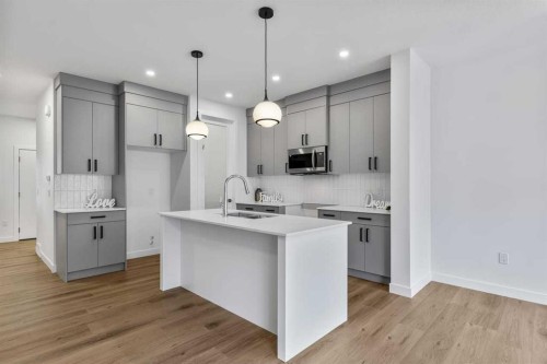 90 Heritage Circle, Cochrane, AB - Indoor Photo Showing Kitchen With Upgraded Kitchen