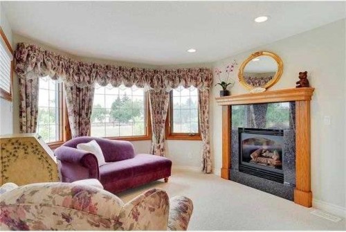 175 Pumpvalley Court Sw, Calgary, AB - Indoor Photo Showing Living Room With Fireplace