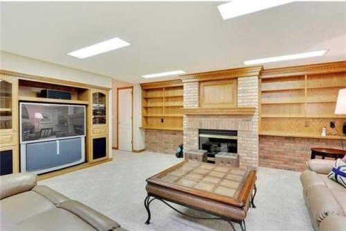175 Pumpvalley Court Sw, Calgary, AB - Indoor Photo Showing Living Room With Fireplace
