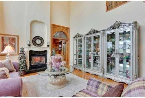 175 Pumpvalley Court Sw, Calgary, AB - Indoor Photo Showing Living Room With Fireplace