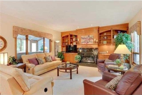 175 Pumpvalley Court Sw, Calgary, AB - Indoor Photo Showing Living Room With Fireplace
