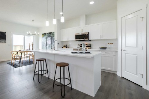 71 Heritage Manor, Cochrane, AB - Indoor Photo Showing Kitchen With Upgraded Kitchen