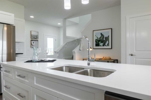 71 Heritage Manor, Cochrane, AB - Indoor Photo Showing Kitchen With Double Sink