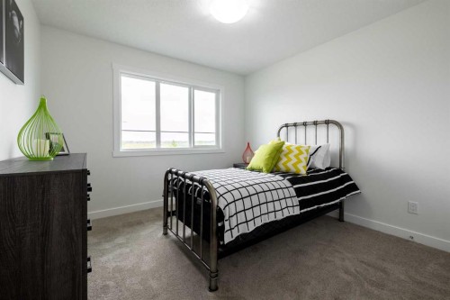 71 Heritage Manor, Cochrane, AB - Indoor Photo Showing Bedroom