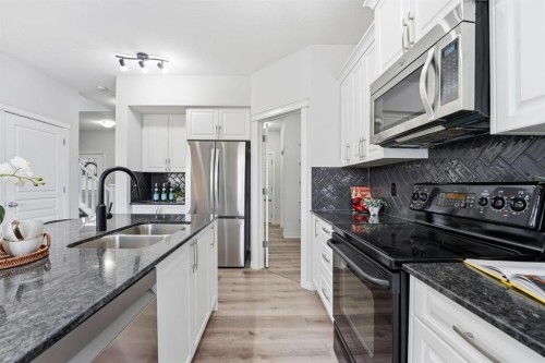 1096 Hillcrest Lane Sw, Airdrie, AB - Indoor Photo Showing Kitchen With Double Sink With Upgraded Kitchen