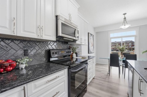 1096 Hillcrest Lane Sw, Airdrie, AB - Indoor Photo Showing Kitchen With Upgraded Kitchen