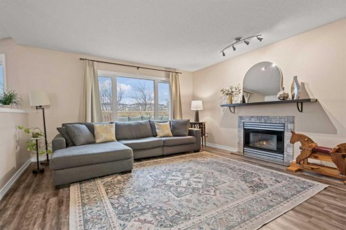 43 Sunset Crescent, Okotoks, AB - Indoor Photo Showing Living Room With Fireplace
