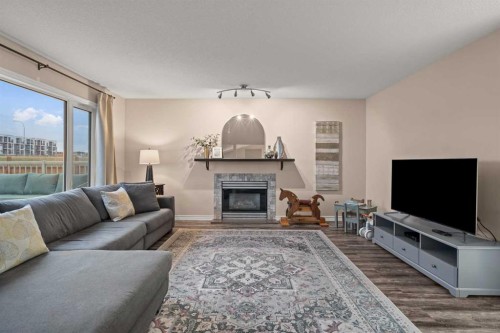 43 Sunset Crescent, Okotoks, AB - Indoor Photo Showing Living Room With Fireplace