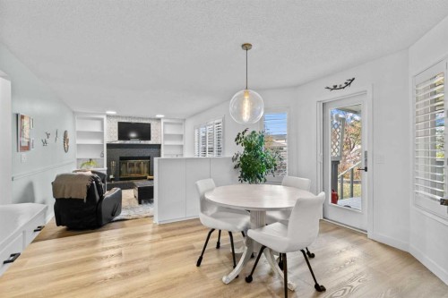 104 Hampshire Close Nw, Calgary, AB - Indoor Photo Showing Dining Room With Fireplace