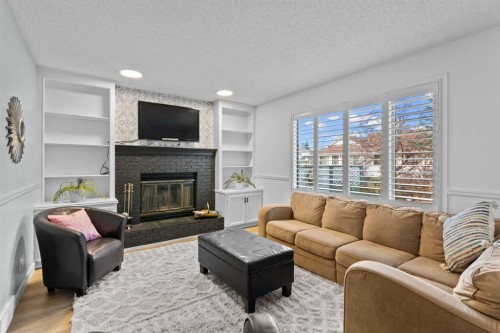 104 Hampshire Close Nw, Calgary, AB - Indoor Photo Showing Living Room With Fireplace