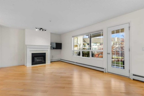 206-2144 Paliswood Road Sw, Calgary, AB - Indoor Photo Showing Living Room With Fireplace