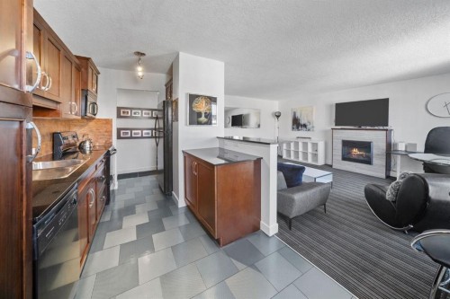 406-1420 Memorial Drive Nw, Calgary, AB - Indoor Photo Showing Kitchen With Fireplace