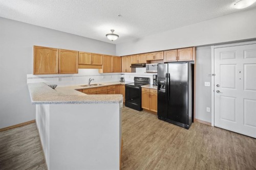 207-200 Lincoln Way Sw, Calgary, AB - Indoor Photo Showing Kitchen With Double Sink