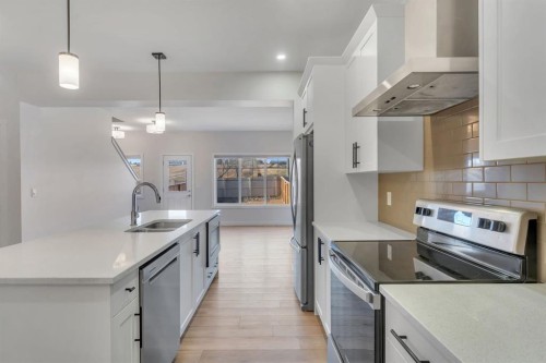 1489 Bayview Point Sw, Airdrie, AB - Indoor Photo Showing Kitchen With Stainless Steel Kitchen With Double Sink With Upgraded Kitchen