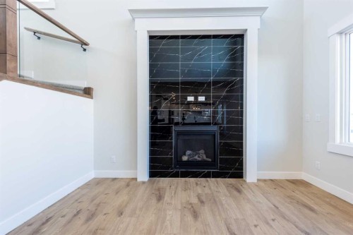 22 Cimarron Estates Gate, Okotoks, AB - Indoor Photo Showing Other Room With Fireplace