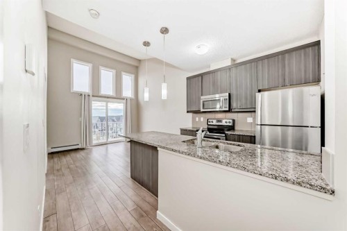 415-402 Marquis Lane Se, Calgary, AB - Indoor Photo Showing Kitchen With Stainless Steel Kitchen With Upgraded Kitchen