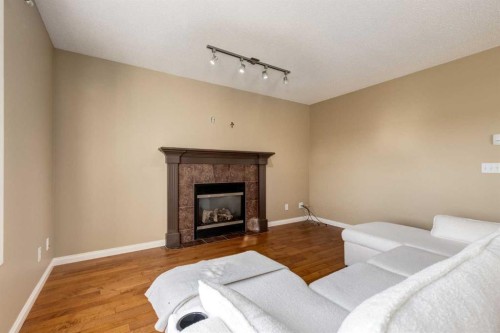 1880 Thornbird Road Se, Airdrie, AB - Indoor Photo Showing Living Room With Fireplace