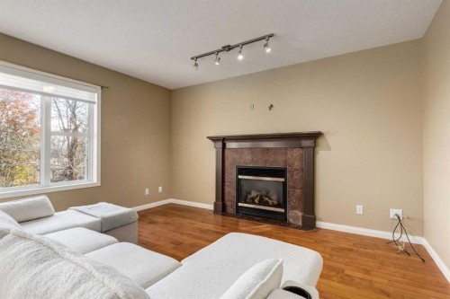 1880 Thornbird Road Se, Airdrie, AB - Indoor Photo Showing Living Room With Fireplace
