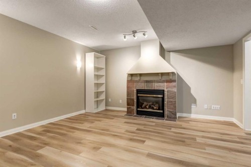1880 Thornbird Road Se, Airdrie, AB - Indoor Photo Showing Living Room With Fireplace
