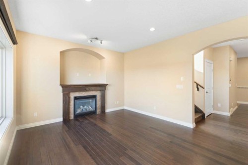 100 Lakeside View, Strathmore, AB - Indoor Photo Showing Living Room With Fireplace