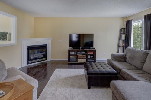 82 Country Hills Cove Nw, Calgary, AB - Indoor Photo Showing Living Room With Fireplace