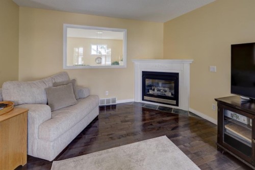 82 Country Hills Cove Nw, Calgary, AB - Indoor Photo Showing Living Room With Fireplace